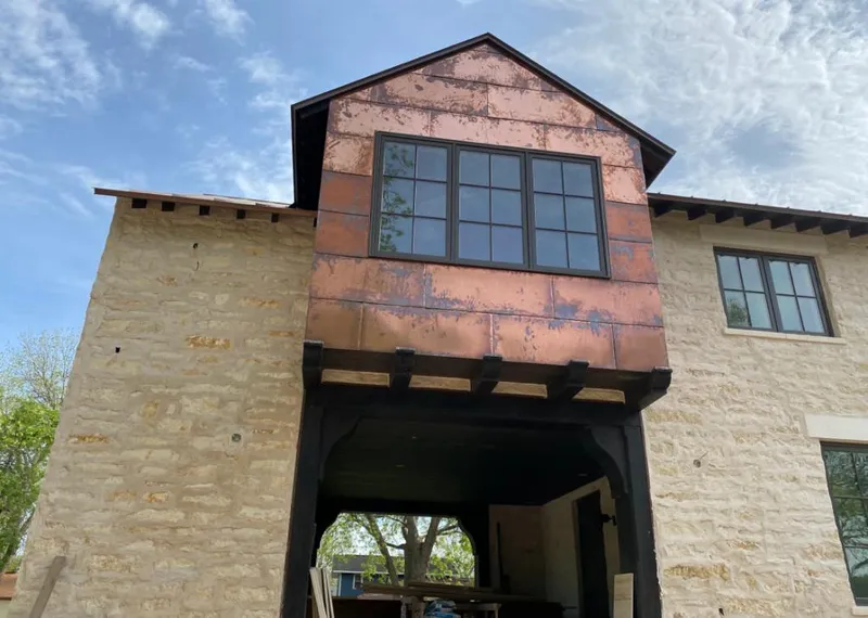 Copper metal panel facade on a stone building for Roof Repair in Warr Acres