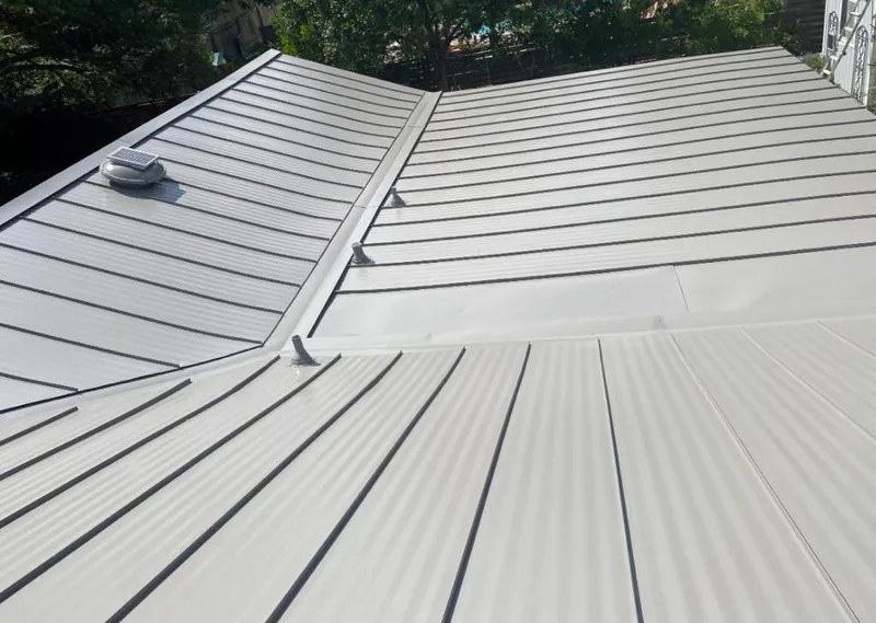 Solar attic fan installed on a metal roof for Roof Ventilation in Warr Acres